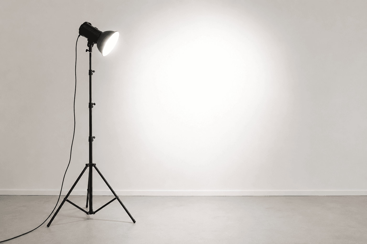 Cinema camera on a tripod with an on-set monitor, lighting rigs, and crew working in a studio
